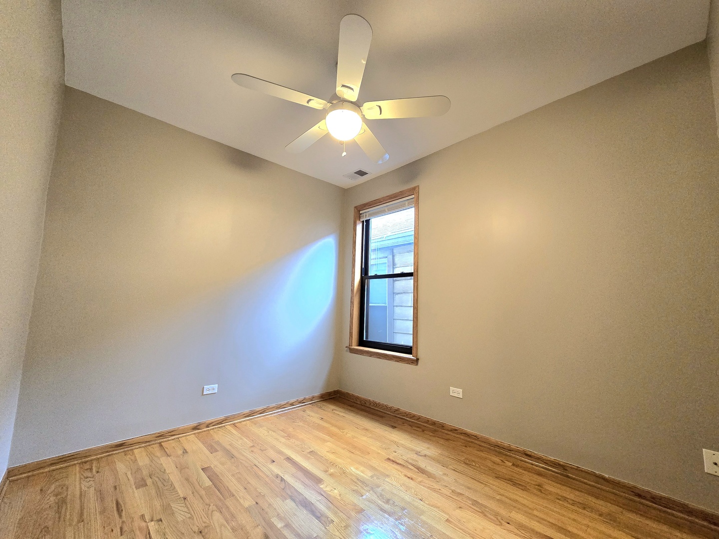 2126 West 24th Street, Unit 2 Chicago, IL 60608 - Photo 9 of 16 an empty room with a chandelier fan and windows
