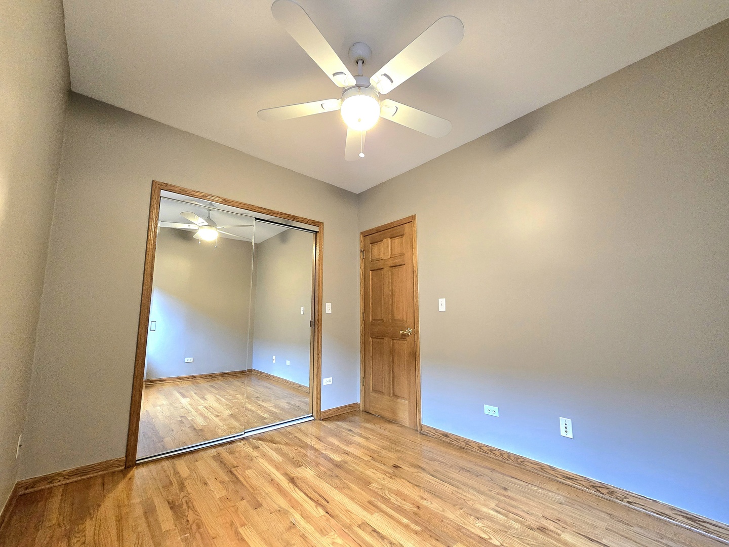 2126 West 24th Street, Unit 2 Chicago, IL 60608 - Photo 10 of 16 wooden floor in an empty room with a window