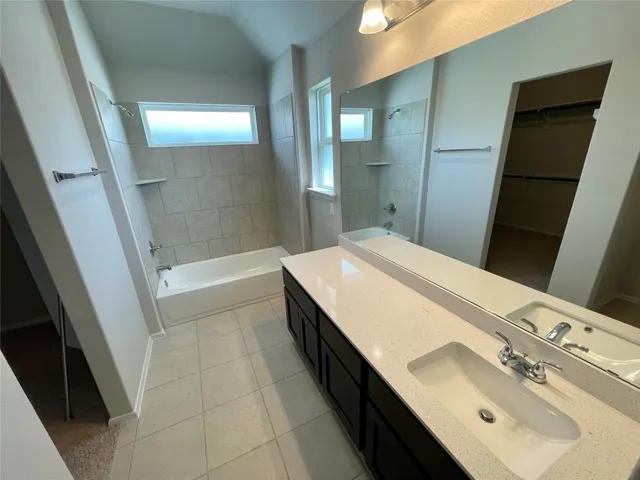a bathroom with a double vanity sink a toilet and a mirror
