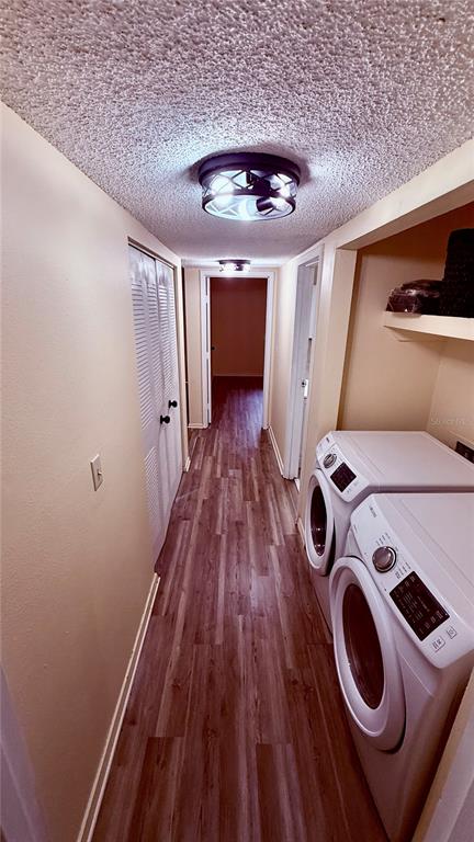 6519 West Newberry Road, Unit 206 Gainesville, FL 32605 - Photo 11 of 14 a view of washer and dryer with wooden floor