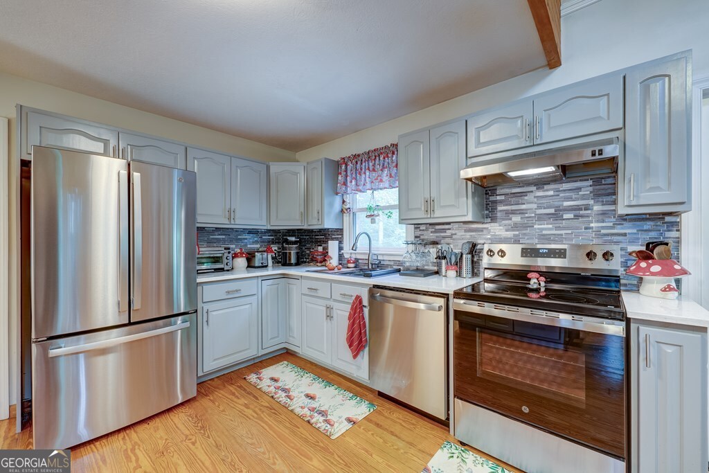 154 Rhapsody Circle Ellijay, GA 30540 - Photo 16 of 64 a kitchen with a refrigerator stove and sink
