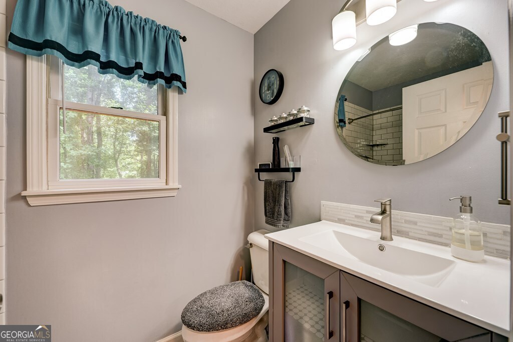 154 Rhapsody Circle Ellijay, GA 30540 - Photo 22 of 64 a bathroom with a sink a mirror and vanity
