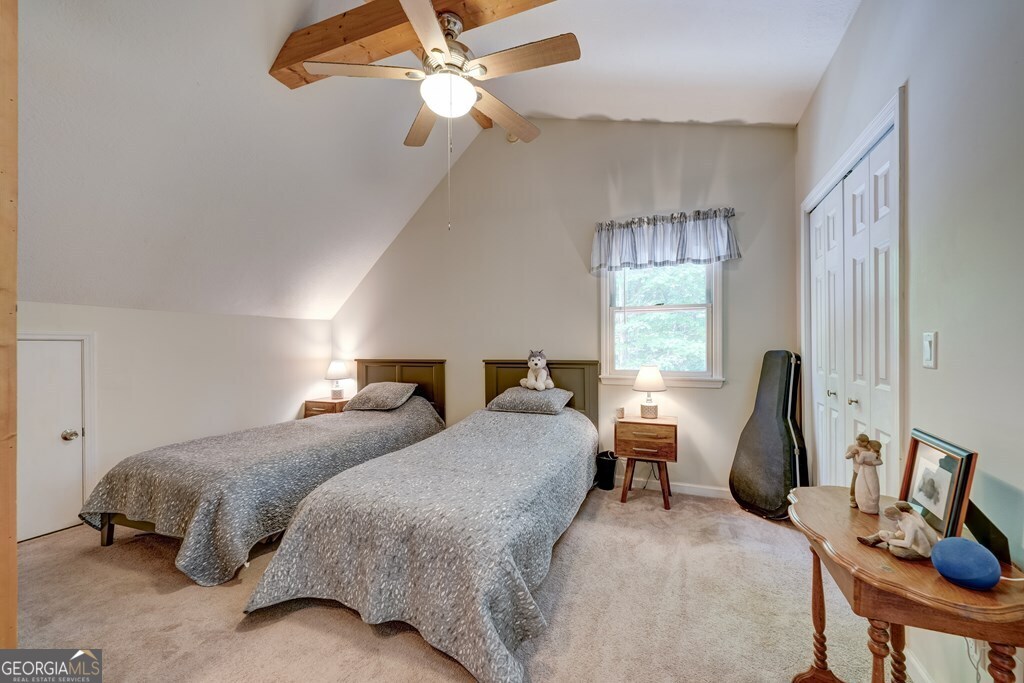 154 Rhapsody Circle Ellijay, GA 30540 - Photo 24 of 64 a bedroom with two beds and a chandelier