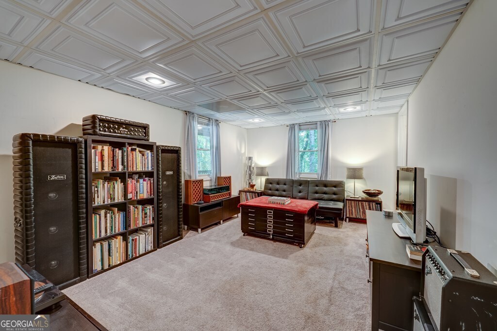 154 Rhapsody Circle Ellijay, GA 30540 - Photo 31 of 64 a living room with furniture a rug and a book shelf