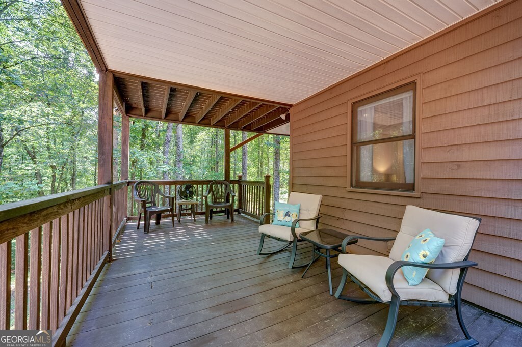 154 Rhapsody Circle Ellijay, GA 30540 - Photo 40 of 64 a view of a chairs and table in patio of the house