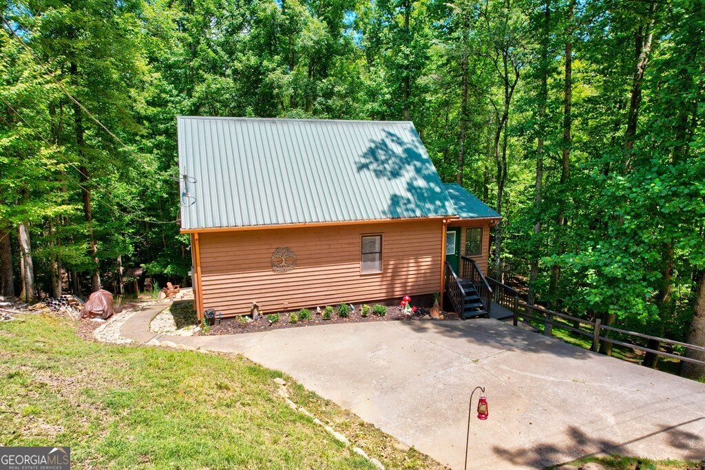 154 Rhapsody Circle Ellijay, GA 30540 - Photo 46 of 64 a backyard of a house with a yard and garage