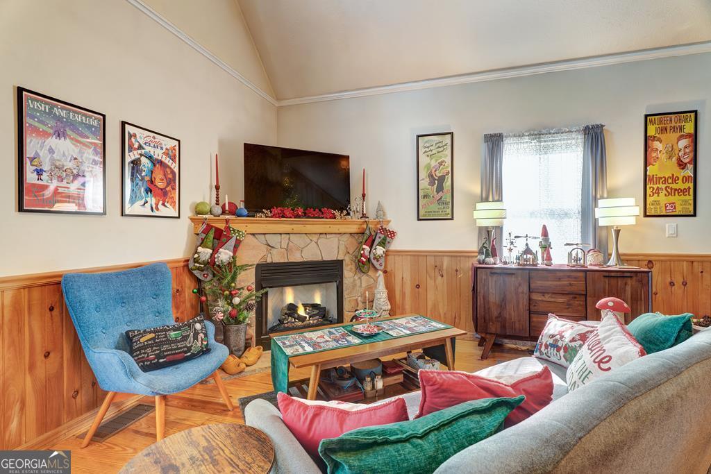 154 Rhapsody Circle Ellijay, GA 30540 - Photo 6 of 64 a living room with furniture a flat screen tv and a fireplace