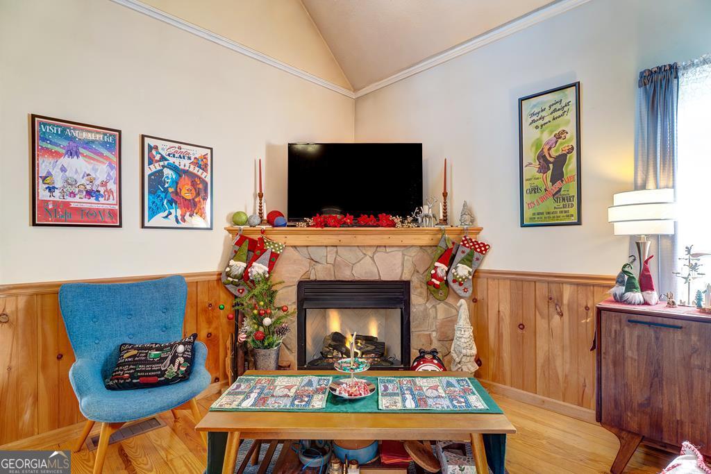 154 Rhapsody Circle Ellijay, GA 30540 - Photo 7 of 64 a living room with furniture a flat screen tv and a fireplace