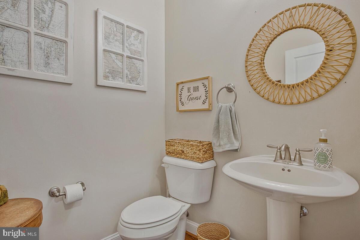 54 Simmons Ridge Road Prince Frederick, MD 20678 - Photo 13 of 55 a bathroom with a toilet a sink and a mirror