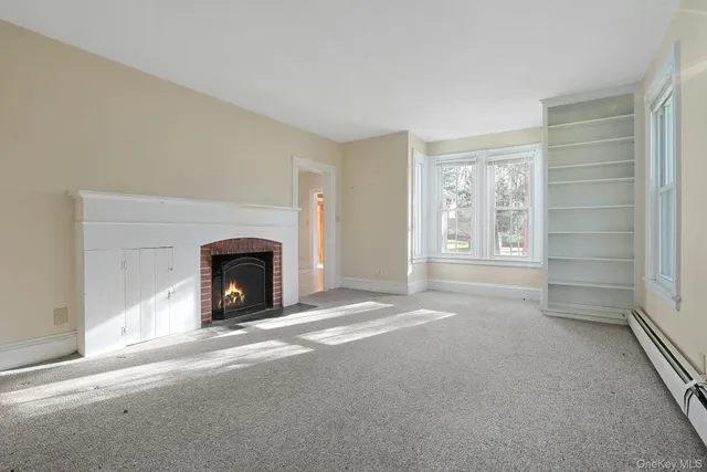 a view of empty room with a fireplace