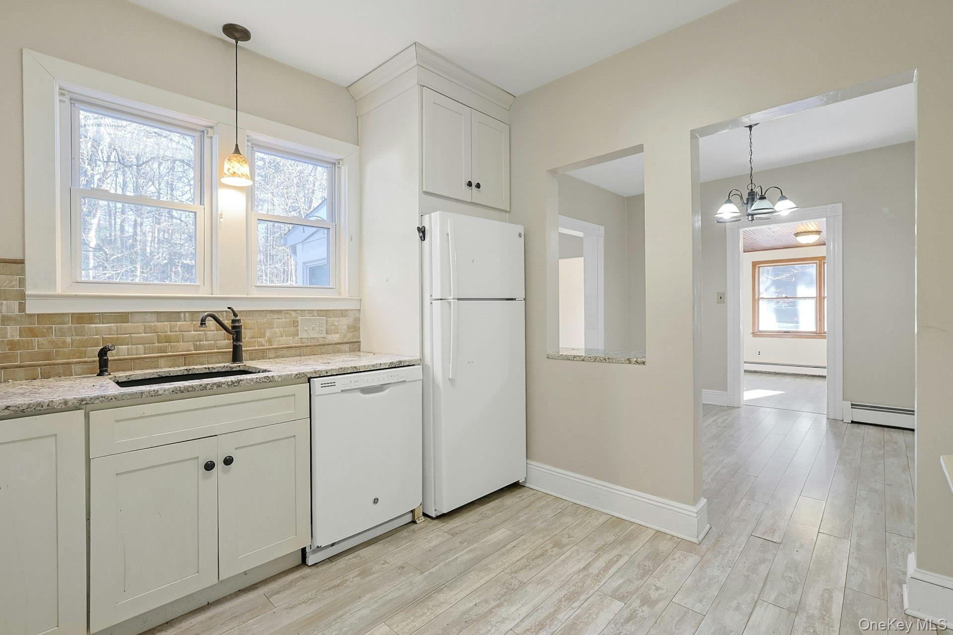 46 Mile Road Montebello, NY 10901 - Photo 2 of 27 a kitchen with a refrigerator sink and cabinets