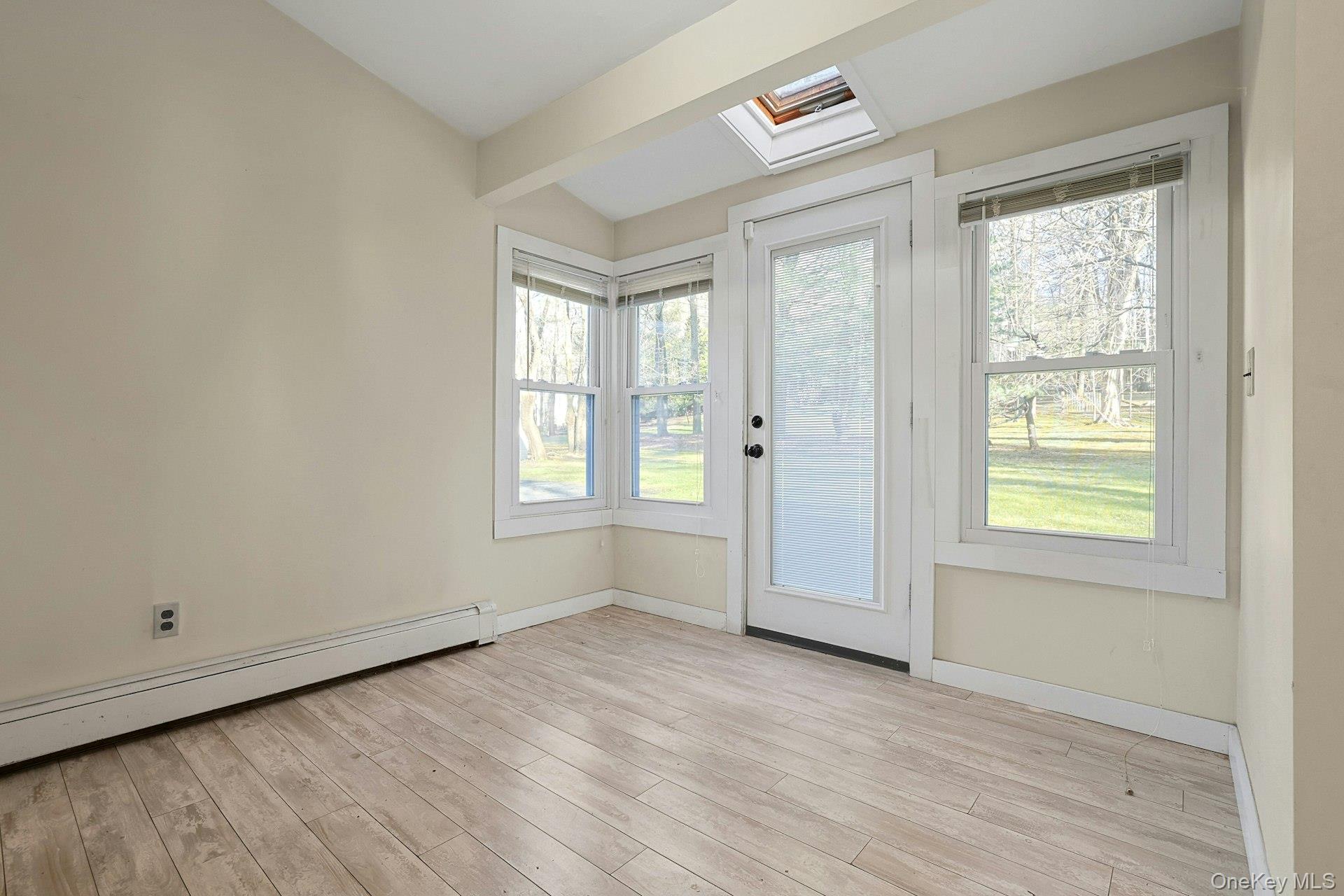 46 Mile Road Montebello, NY 10901 - Photo 7 of 27 an empty room with wooden floor and windows
