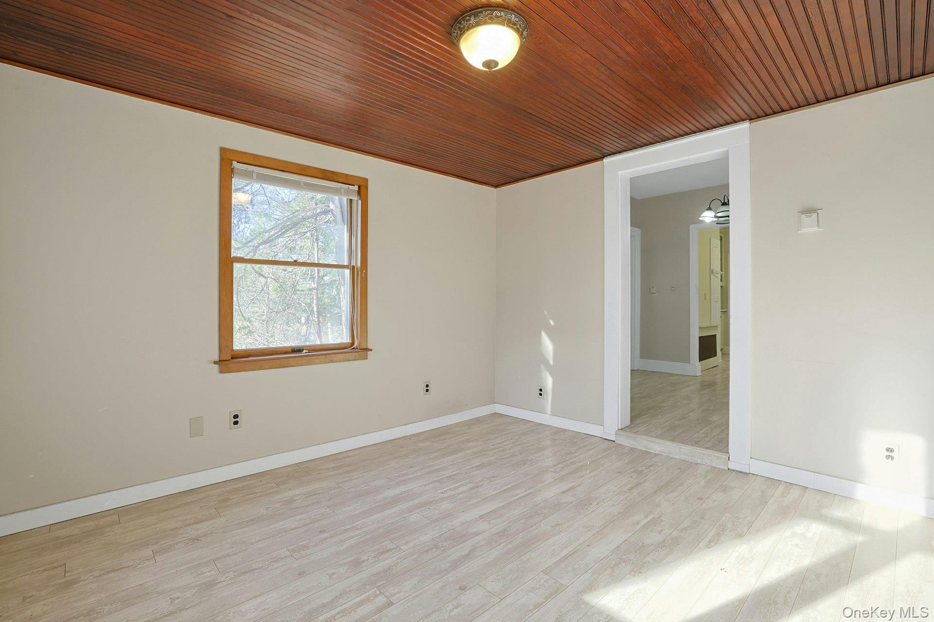 46 Mile Road Montebello, NY 10901 - Photo 10 of 27 an empty room with wooden floor and windows