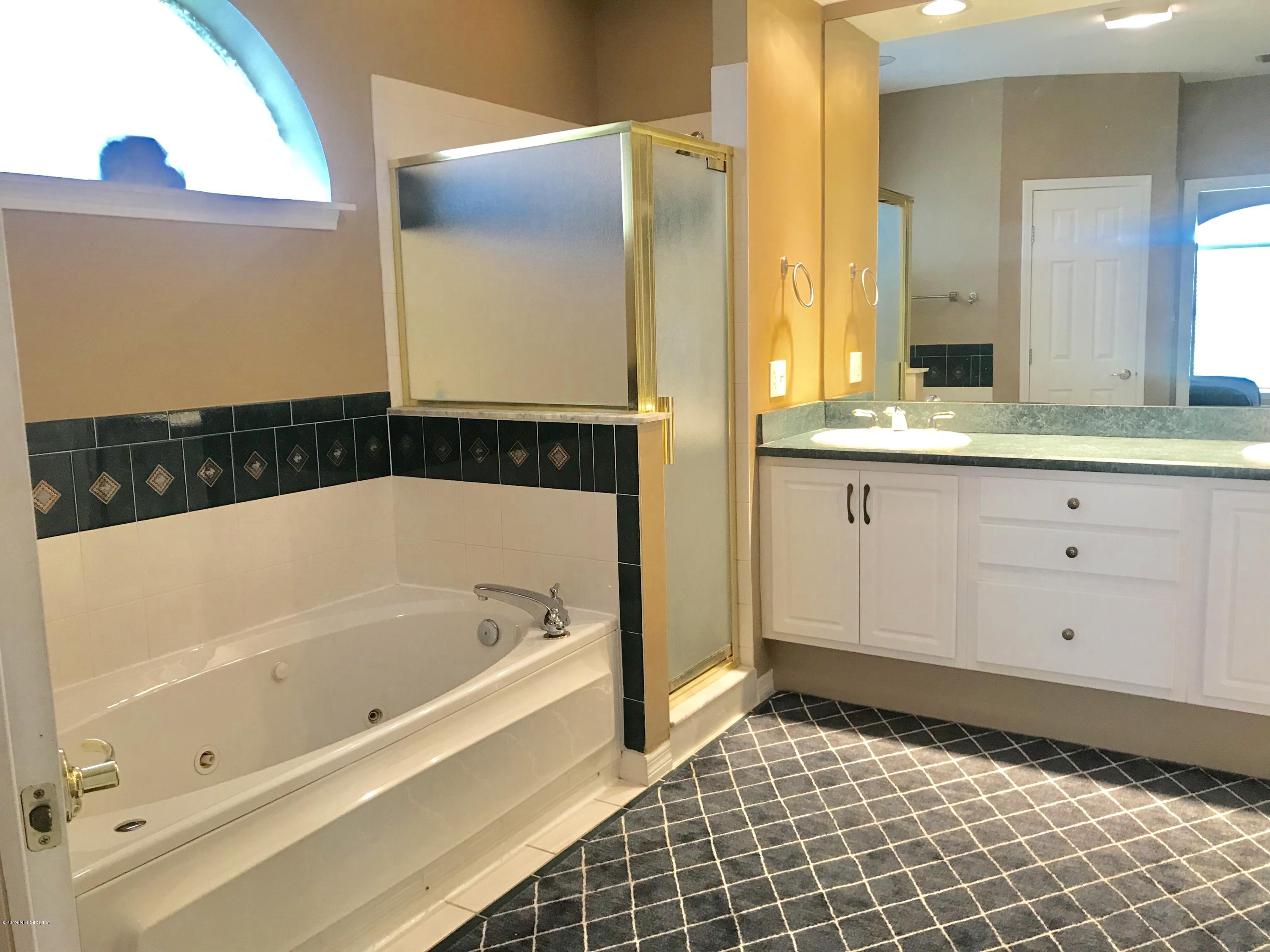 5030 Datil Pepper Road St. Augustine, FL 32086 - Photo 42 of 52 a bathroom with a bathtub and a sink