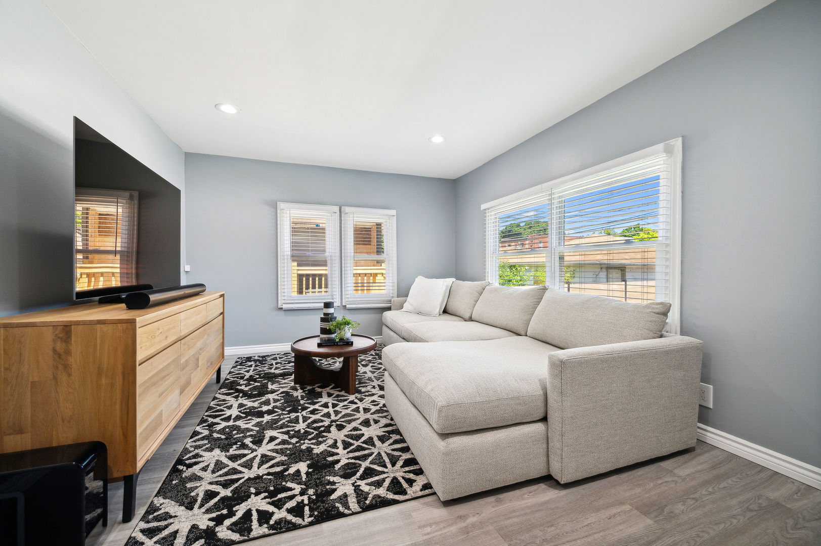 4630 West Montana Street Chicago, IL 60639 - Photo 12 of 38 a living room with furniture a flat screen tv and a window