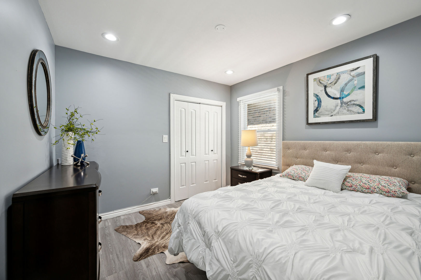 4630 West Montana Street Chicago, IL 60639 - Photo 15 of 38 a bedroom with a large bed and a chandelier