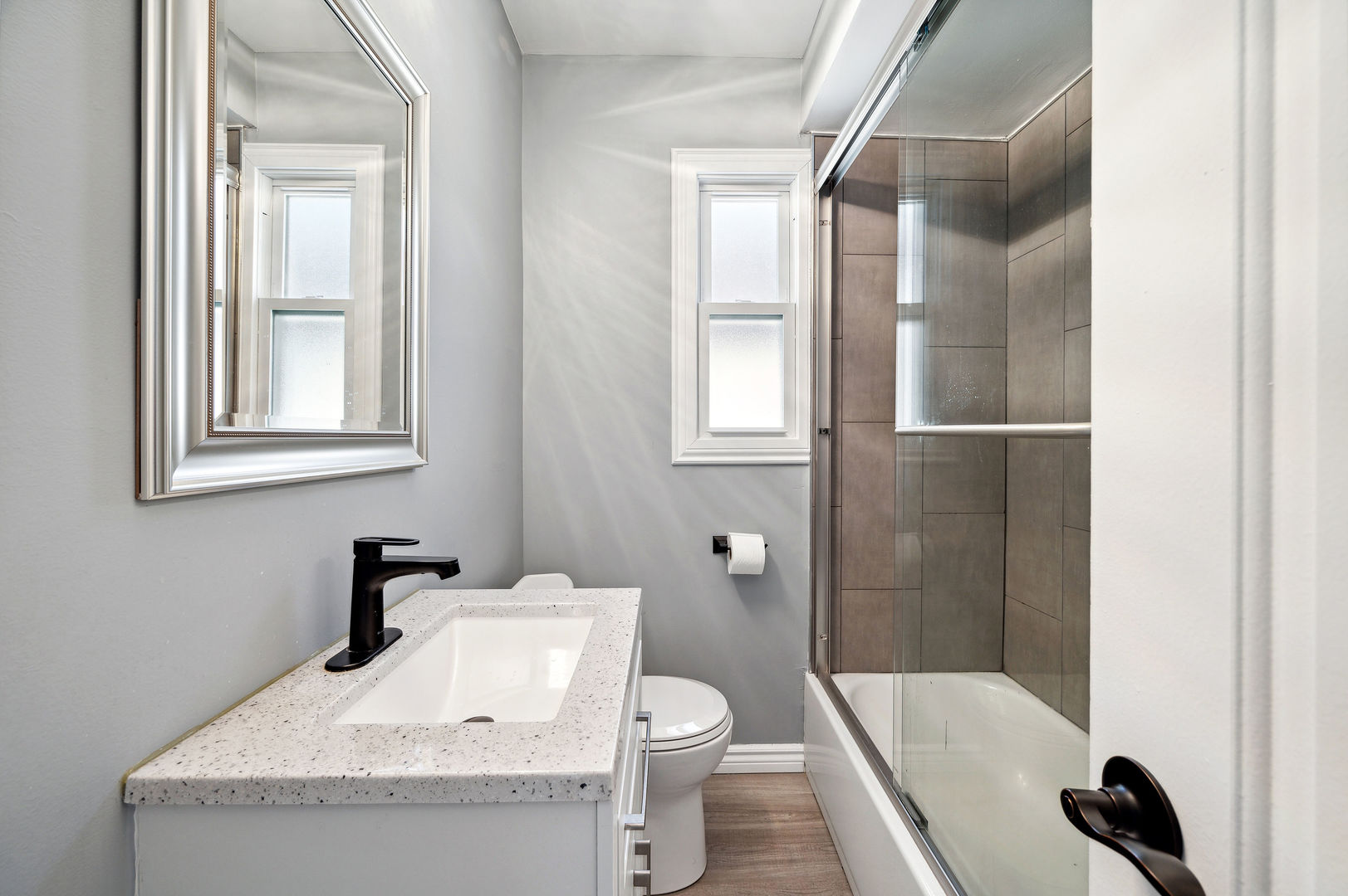 4630 West Montana Street Chicago, IL 60639 - Photo 16 of 38 a bathroom with a granite countertop sink toilet and shower
