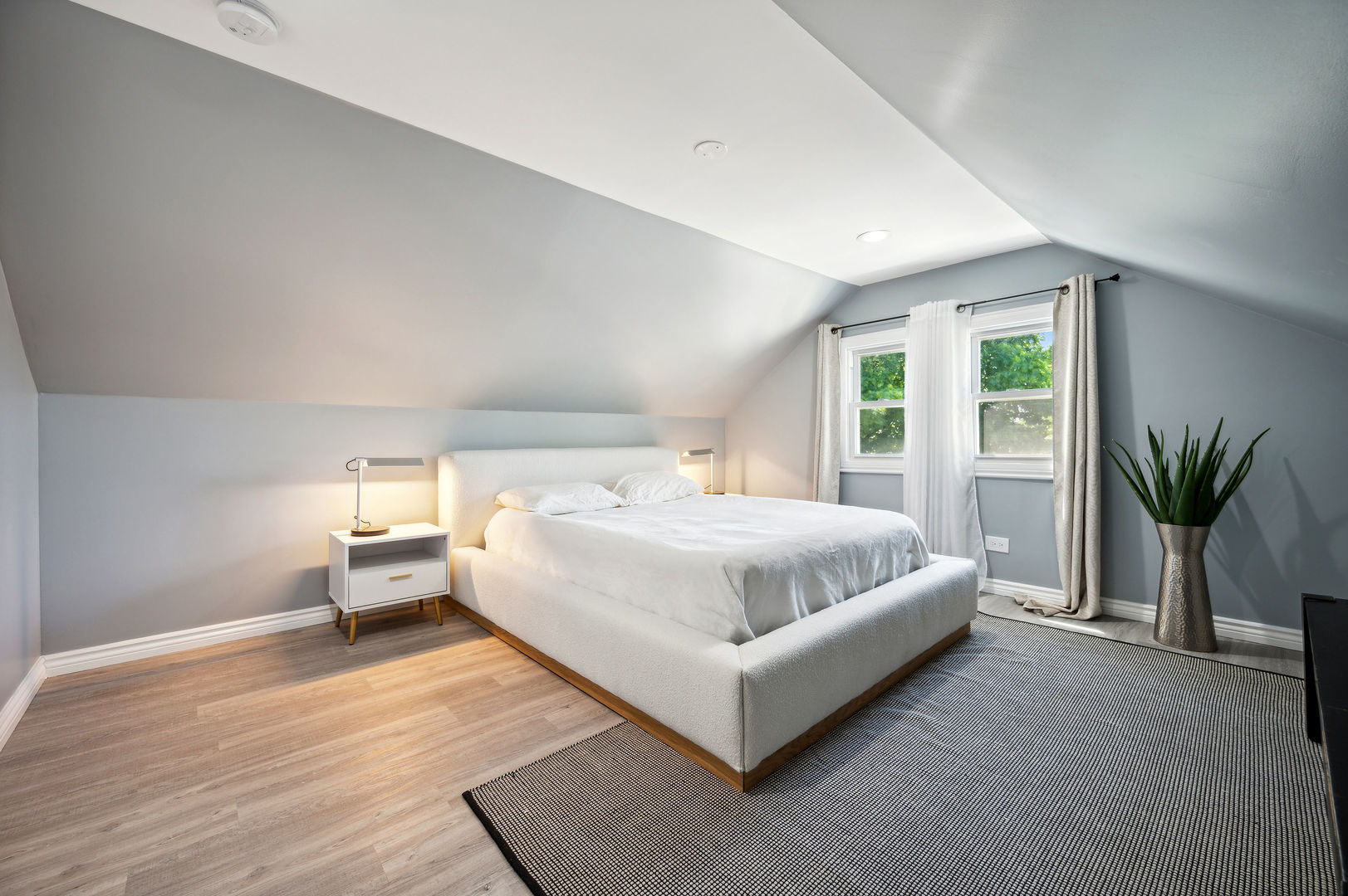 4630 West Montana Street Chicago, IL 60639 - Photo 20 of 38 a spacious bedroom with a bed and a potted plant