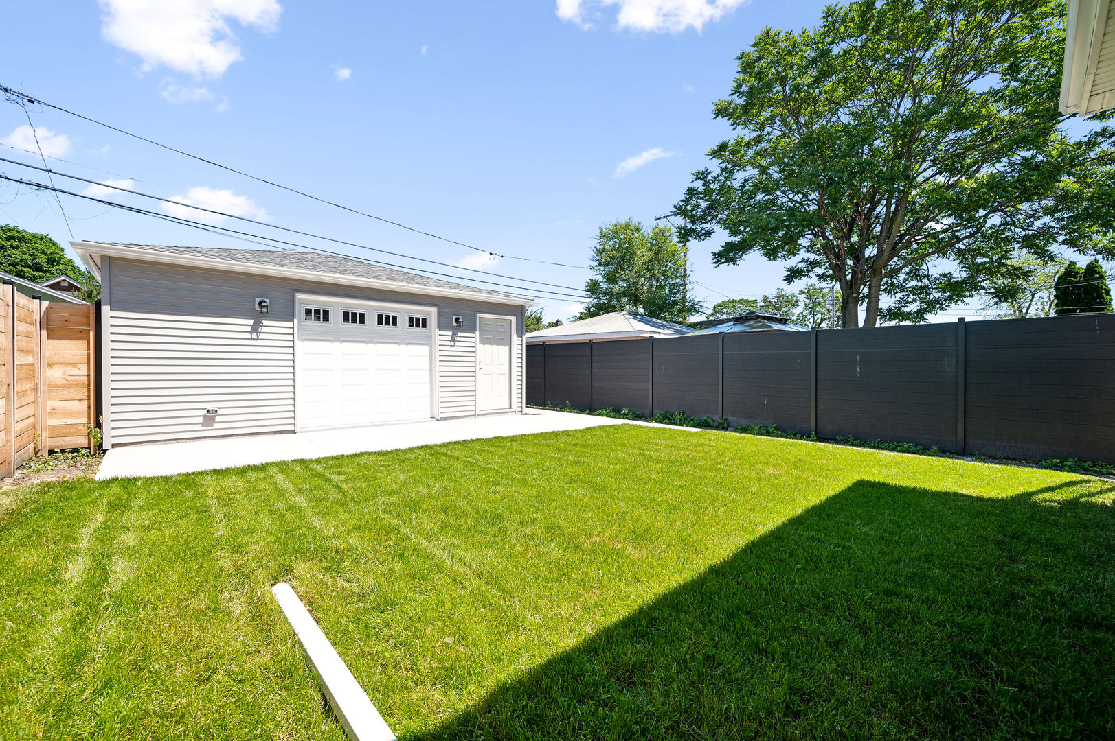 4630 West Montana Street Chicago, IL 60639 - Photo 30 of 38 a view of a backyard with a large tree