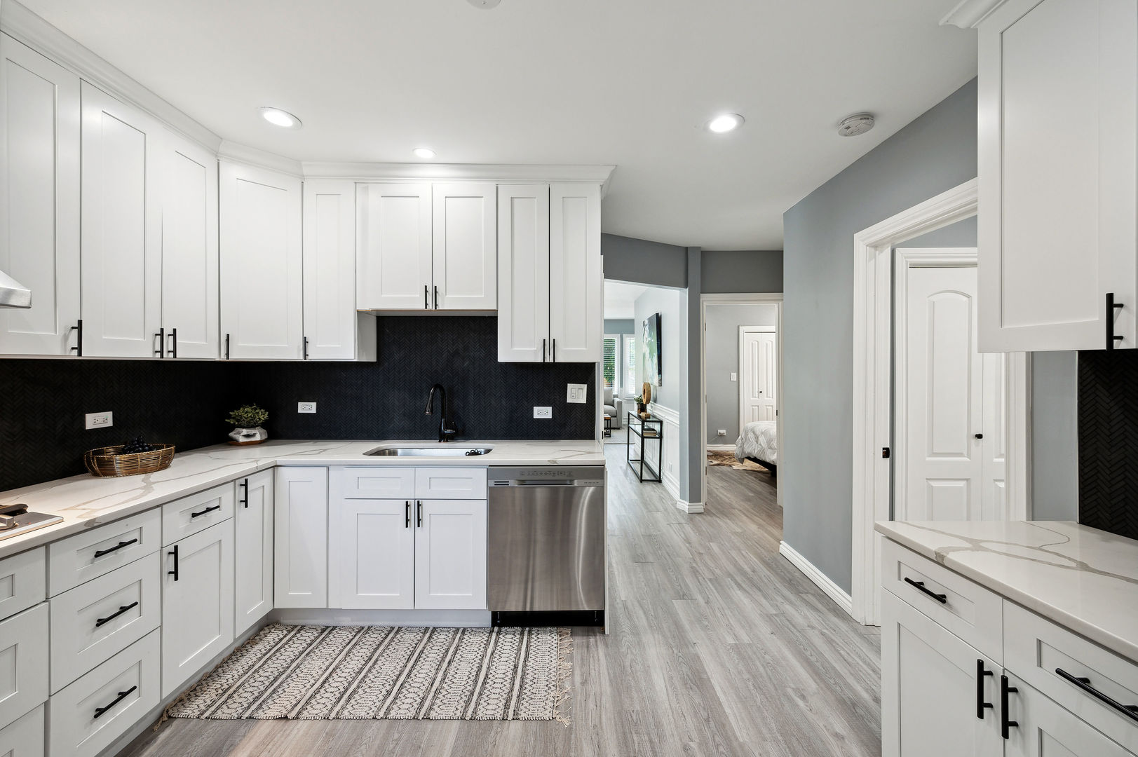4630 West Montana Street Chicago, IL 60639 - Photo 9 of 38 a kitchen with stainless steel appliances granite countertop a stove a sink and white cabinets