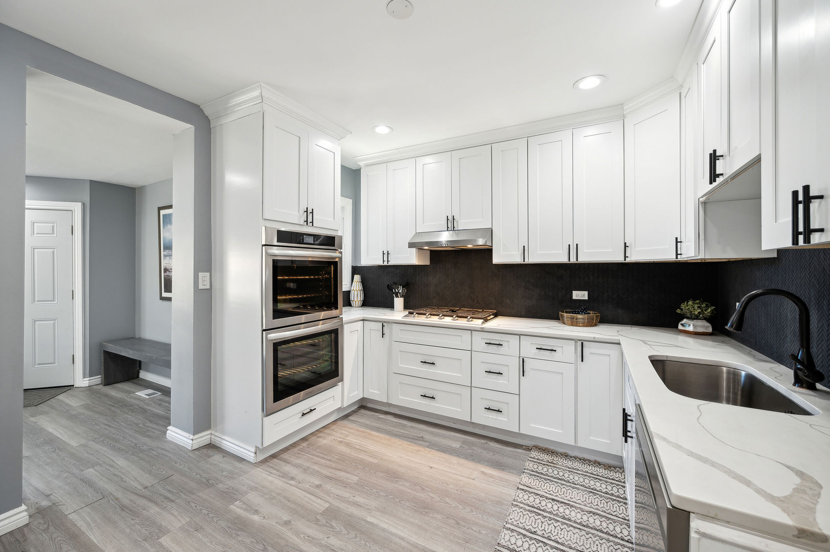 4630 West Montana Street Chicago, IL 60639 - Photo 10 of 38 a kitchen with stainless steel appliances granite countertop a stove a sink and a microwave