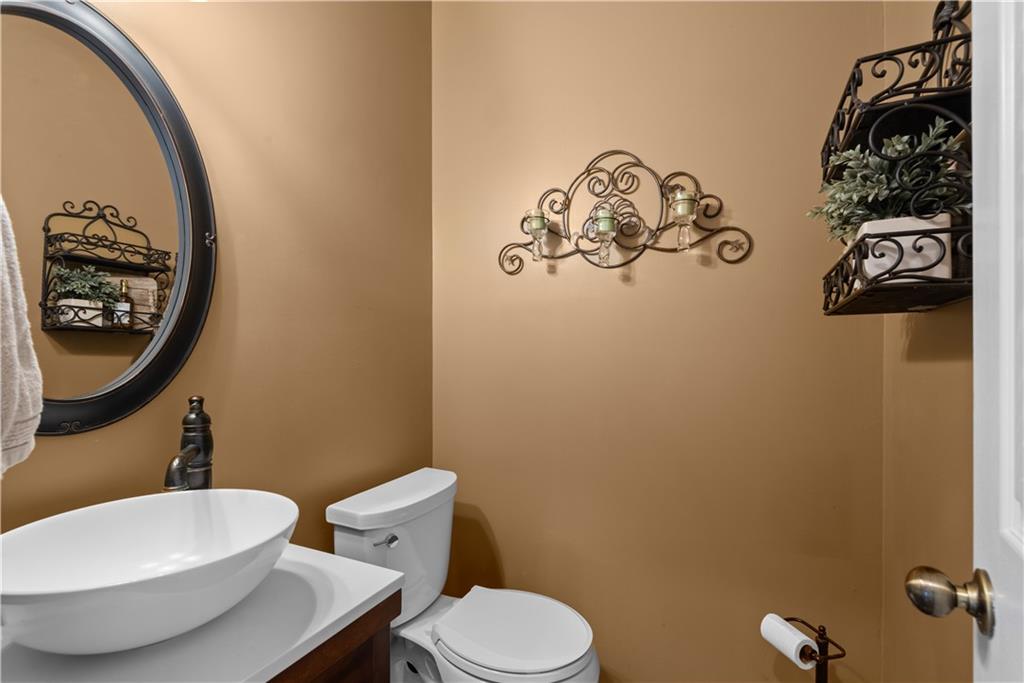 414 Parker Branch Road Barnesville, GA 30204 - Photo 12 of 101 a bathroom with a toilet a sink and mirror