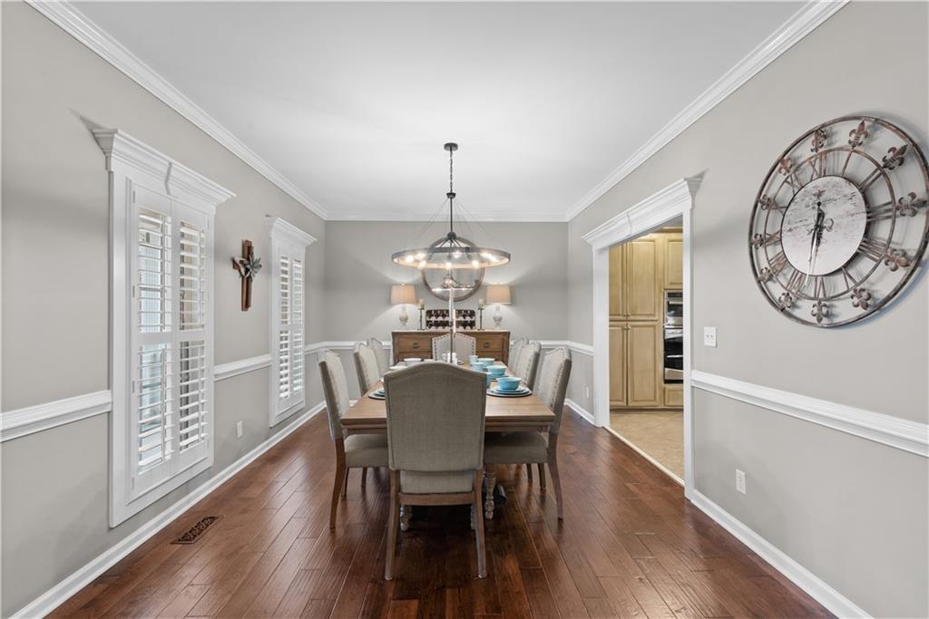 414 Parker Branch Road Barnesville, GA 30204 - Photo 14 of 101 a dining room with furniture a chandelier and wooden floor