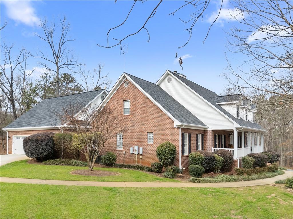 414 Parker Branch Road Barnesville, GA 30204 - Photo 2 of 101 a front view of a house with a garden