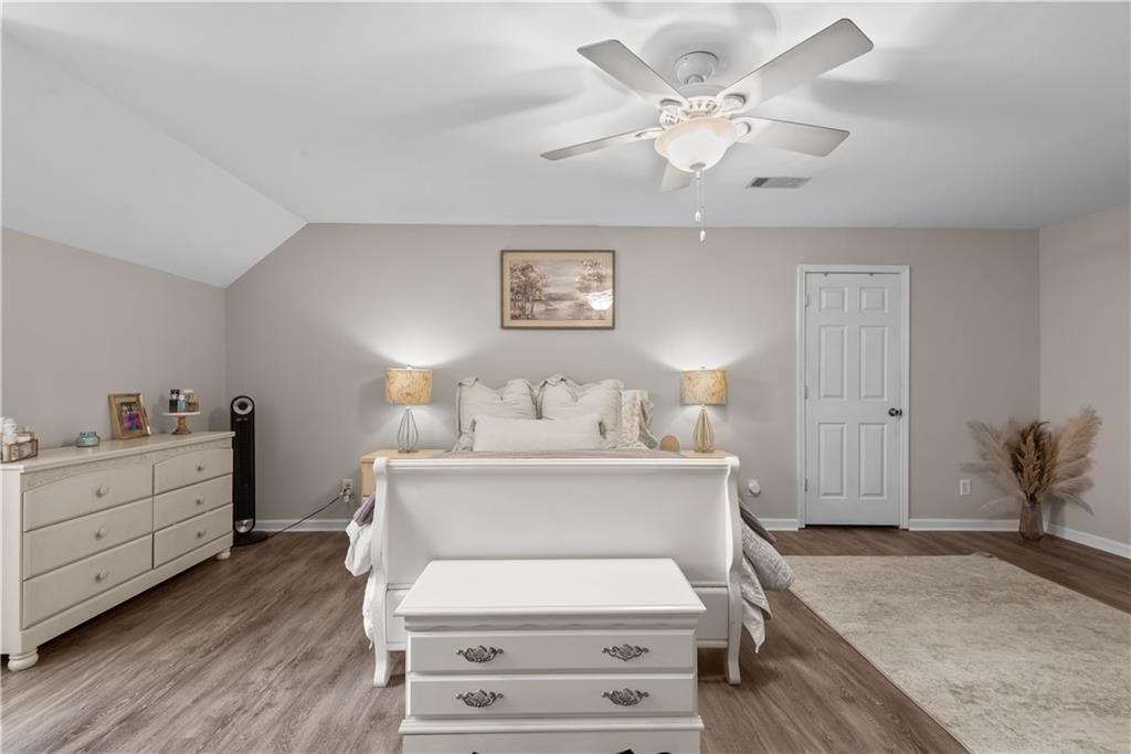 414 Parker Branch Road Barnesville, GA 30204 - Photo 46 of 101 a spacious bedroom with a bed and a chandelier
