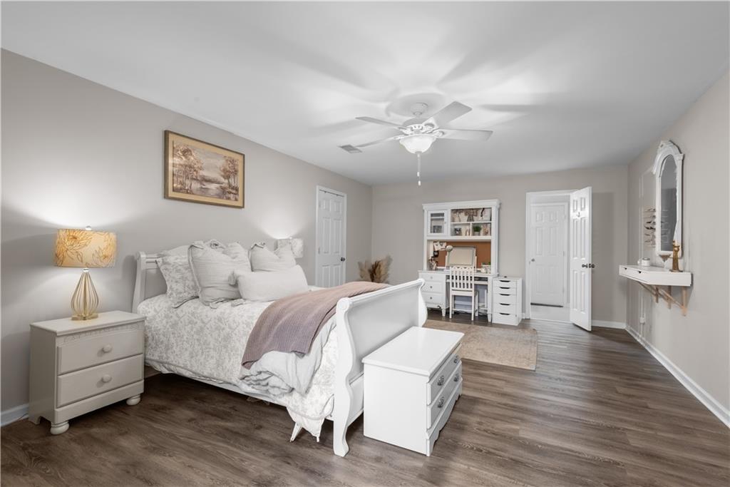 414 Parker Branch Road Barnesville, GA 30204 - Photo 47 of 101 a spacious bedroom with a bed and a chandelier