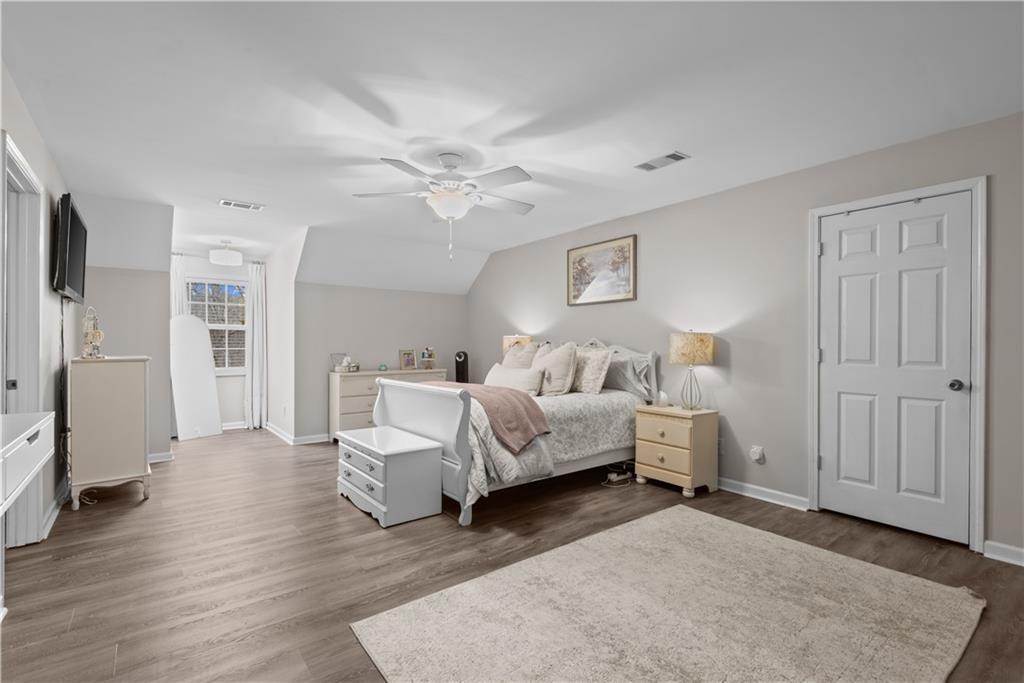 414 Parker Branch Road Barnesville, GA 30204 - Photo 48 of 101 a spacious bedroom with a bed and a couch
