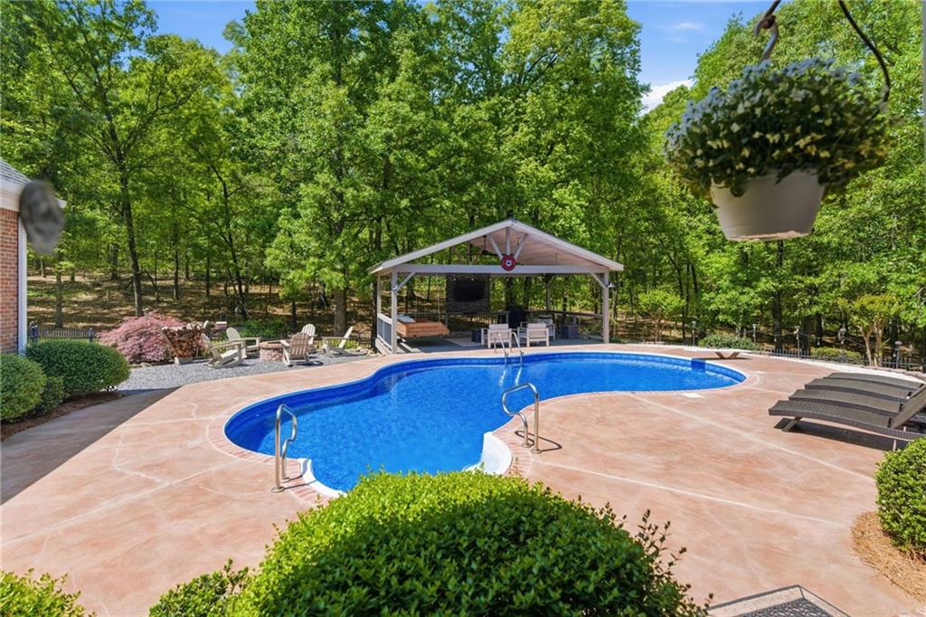414 Parker Branch Road Barnesville, GA 30204 - Photo 48 of 83 a view of pool with table and chairs under an umbrella