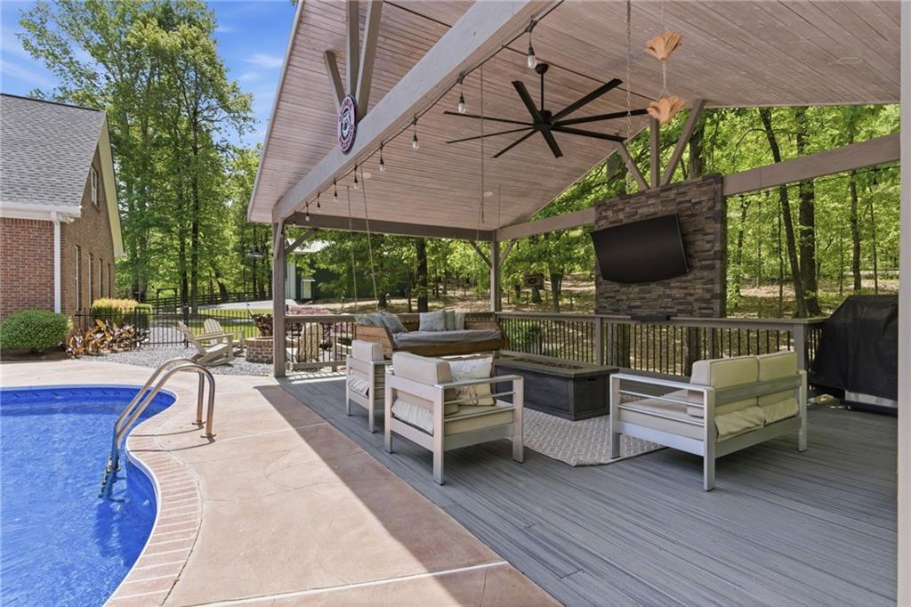 414 Parker Branch Road Barnesville, GA 30204 - Photo 50 of 83 a view of a patio with a dining table and chairs with wooden floor