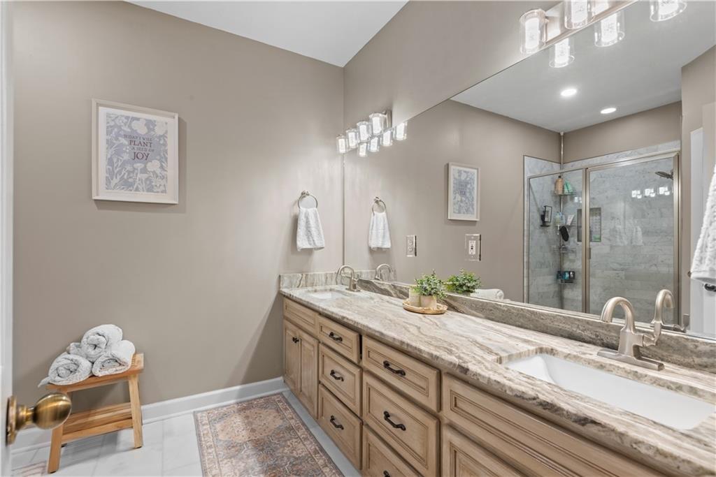 414 Parker Branch Road Barnesville, GA 30204 - Photo 52 of 101 a bathroom with a double vanity sink and a mirror