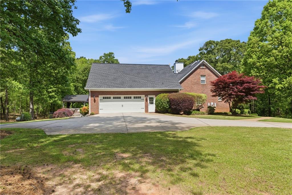 414 Parker Branch Road Barnesville, GA 30204 - Photo 55 of 83 a front view of a house with a yard and garage