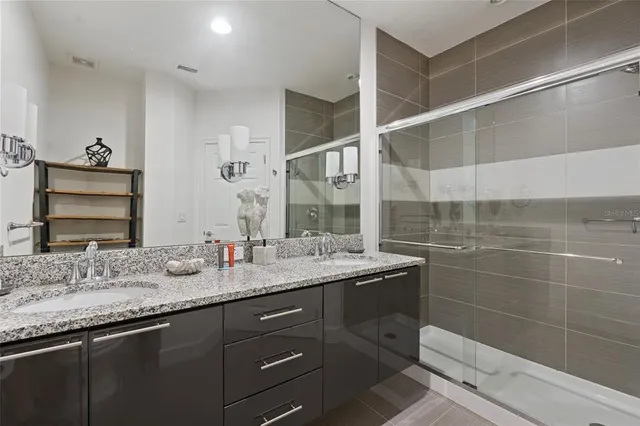a bathroom with a granite countertop sink a mirror and a