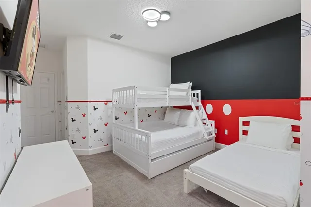 a bed room with a bed and a television