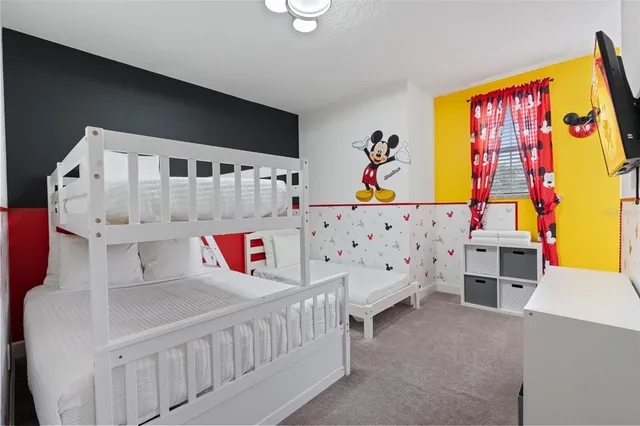 a bedroom with furniture and baby bed