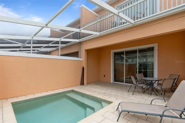 a view of a patio with table and chairs with wooden floor