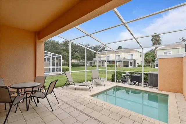 a view of swimming pool with seating area and furniture