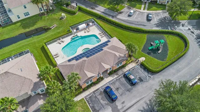 an aerial view of a house a yard and a swimming pool