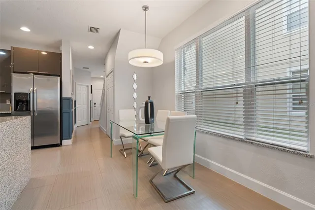 a view of a dining room with furniture and a large window