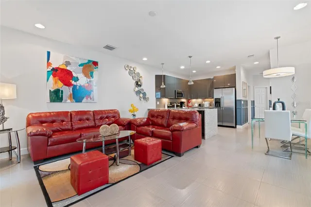 a living room with furniture kitchen view and a kitchen