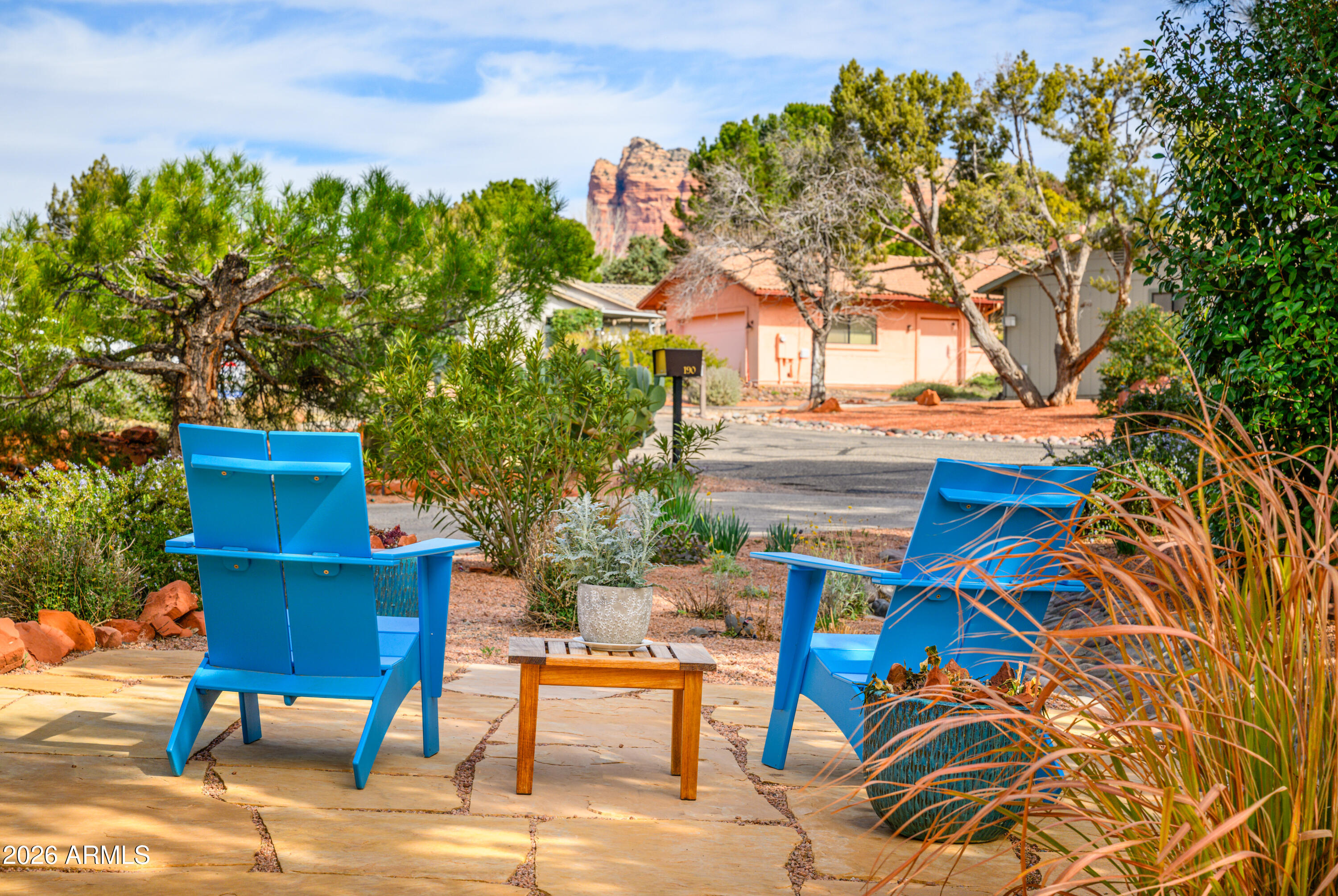 190 Creek Rock Road Sedona, AZ 86351 - Photo 3 of 41 a backyard of a house with table and chairs