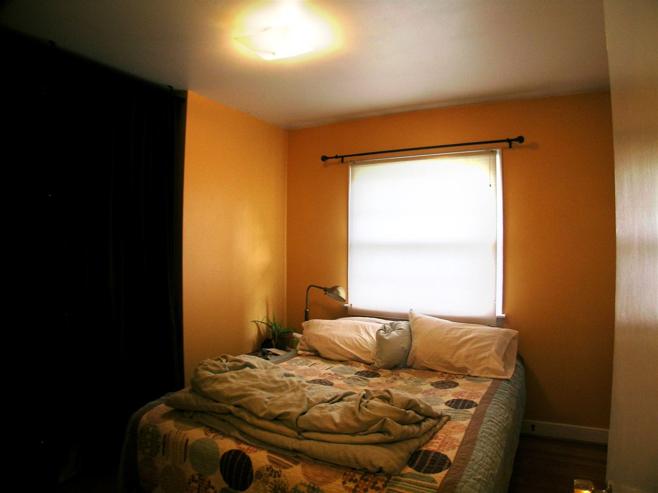 1244 Holmes Avenue Charlottesville, VA 22901 - Photo 12 of 19 a bed sitting in a bedroom next to a window