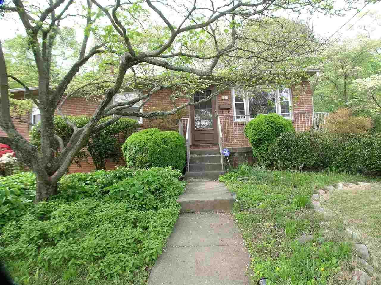1244 Holmes Avenue Charlottesville, VA 22901 - Photo 2 of 19 a front view of a house with a yard and fountain in middle