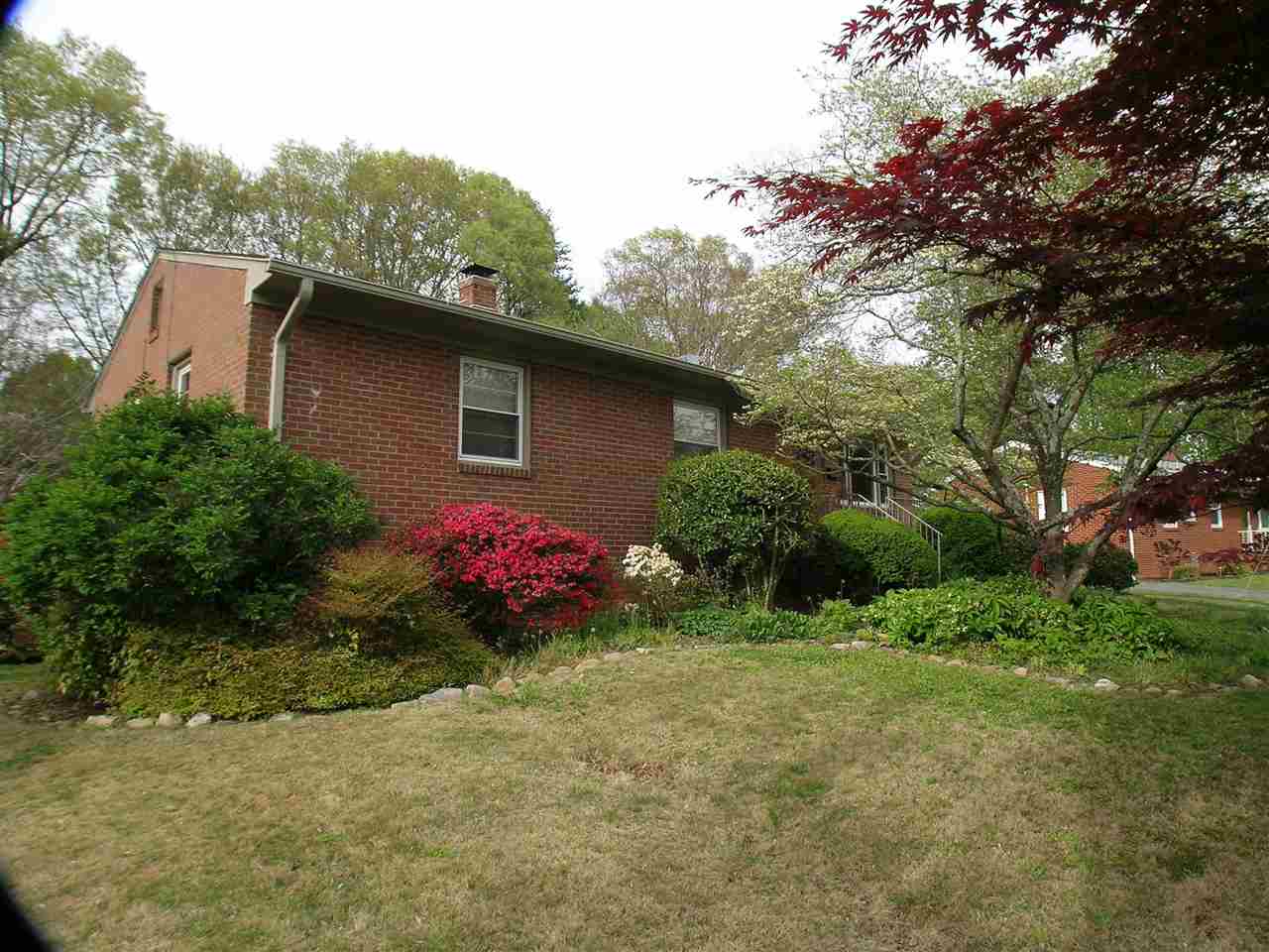 1244 Holmes Avenue Charlottesville, VA 22901 - Photo 4 of 19 a front view of a house with a yard and garage