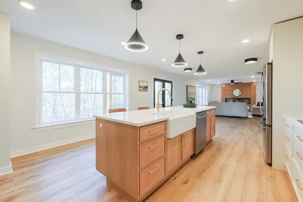 a spacious bedroom with a large bed and a chandelier