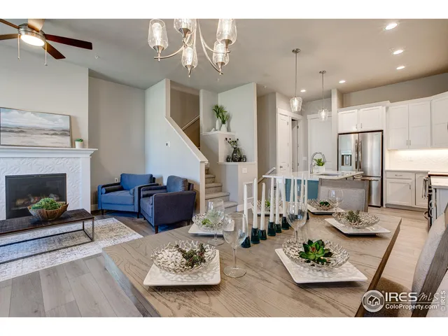 a living room with furniture kitchen view and a fireplace
