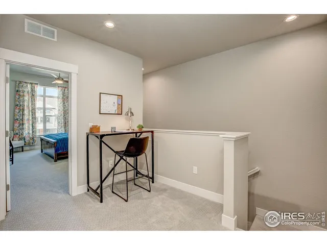 a bedroom with a bed window and a chandelier